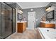 Bathroom featuring dual sinks, walk-in shower and patterned wallpaper at 1633 Lakestone Village Ln, Fuquay Varina, NC 27526