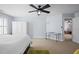 Spacious bedroom with a white ceiling and walls, featuring carpeted floors and a ceiling fan at 1633 Lakestone Village Ln, Fuquay Varina, NC 27526