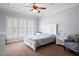 Bright bedroom with a coffered ceiling, large windows, and a queen-sized bed at 1633 Lakestone Village Ln, Fuquay Varina, NC 27526