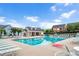 Sparkling community pool surrounded by lounge chairs, with a clubhouse and well-maintained landscaping at 1633 Lakestone Village Ln, Fuquay Varina, NC 27526