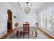 Elegant dining room with coffered ceiling, chandelier, hardwood floors, and natural light at 1633 Lakestone Village Ln, Fuquay Varina, NC 27526