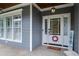 Charming home featuring a welcoming front door with glass accents, a wreath, and decorative home sign at 1633 Lakestone Village Ln, Fuquay Varina, NC 27526