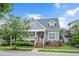 Charming gray home featuring a well-manicured front yard and inviting porch at 1633 Lakestone Village Ln, Fuquay Varina, NC 27526