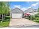 Spacious two-car garage with a concrete driveway and well-manicured landscaping at 1633 Lakestone Village Ln, Fuquay Varina, NC 27526