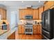 Charming kitchen with wood cabinets, granite counters, and modern stainless steel appliances at 1633 Lakestone Village Ln, Fuquay Varina, NC 27526