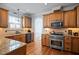 Well-equipped kitchen with granite countertops, stainless steel appliances, and wood cabinetry at 1633 Lakestone Village Ln, Fuquay Varina, NC 27526