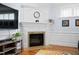 Bright living room features a white fireplace with granite and a decorative mantle at 1633 Lakestone Village Ln, Fuquay Varina, NC 27526