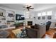 Well-lit living room with a decorative fireplace, shelving and comfortable seating at 1633 Lakestone Village Ln, Fuquay Varina, NC 27526