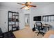 Well-lit office with dual monitors, modern desk, black shelving and carpeted floors at 1633 Lakestone Village Ln, Fuquay Varina, NC 27526