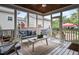 Cozy screened porch with white wood floors, ceiling fan and comfortable seating with access to a brick patio at 1633 Lakestone Village Ln, Fuquay Varina, NC 27526