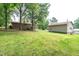 Large, level backyard featuring a brick home and large detached garage at 1822 Routh Rd, Burlington, NC 27217