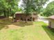 Aerial view of home's well-maintained backyard, perfect for entertaining and relaxation, surrounded by mature trees at 1822 Routh Rd, Burlington, NC 27217