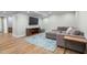 Finished basement featuring a gray sectional, mounted TV, and area rug at 1822 Routh Rd, Burlington, NC 27217