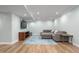 Finished basement with comfortable seating, hardwood floors, recessed lighting, and entertainment center at 1822 Routh Rd, Burlington, NC 27217