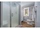 Stylish bathroom features a glass shower and a brick accent wall at 1822 Routh Rd, Burlington, NC 27217