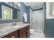 Bathroom featuring a granite countertop vanity and a glass-enclosed shower at 1822 Routh Rd, Burlington, NC 27217
