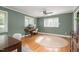 Bright bedroom with windows, wooden desk, and hardwood floors at 1822 Routh Rd, Burlington, NC 27217