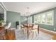 Dining area with a wooden table, modern chairs, and natural light from nearby windows at 1822 Routh Rd, Burlington, NC 27217
