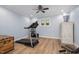 Bright exercise room with a treadmill, ceiling fan, and wood flooring at 1822 Routh Rd, Burlington, NC 27217