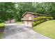 The exterior boasts a long driveway, two-car garage, and well-maintained landscaping at 1822 Routh Rd, Burlington, NC 27217