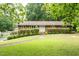 Charming brick home with well-maintained landscaping and a curved walkway to the front door at 1822 Routh Rd, Burlington, NC 27217