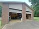 A large detached two-car garage, complete with open doors, ample workspace and storage, great for any hobbyist at 1822 Routh Rd, Burlington, NC 27217