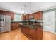 Bright kitchen with stainless steel appliances, large center island, and ample cabinet space at 1822 Routh Rd, Burlington, NC 27217
