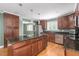 Spacious kitchen with dark wood cabinets, granite countertops, and stainless steel appliances at 1822 Routh Rd, Burlington, NC 27217