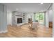 Cozy living room with a brick fireplace, wooden shelves, and sliding glass doors at 1822 Routh Rd, Burlington, NC 27217