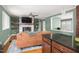 Open-concept living space with seamless flow to the kitchen, featuring a brick fireplace at 1822 Routh Rd, Burlington, NC 27217