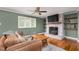 Cozy living room with a brick fireplace, decorative shelves, and ample seating space at 1822 Routh Rd, Burlington, NC 27217