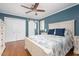 Spacious main bedroom with wood floors, white furniture, and a ceiling fan and large closet at 1822 Routh Rd, Burlington, NC 27217