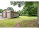 Large detached garage, with a yard and many mature trees at 1822 Routh Rd, Burlington, NC 27217