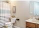 Neutral bathroom featuring a toilet, sink with vanity, medicine cabinet and striped shower curtain at 1833 Creek Oak Circle Cir, Fuquay Varina, NC 27526