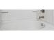 Close up of white bathtub with brushed silver fixtures and white tile at 1833 Creek Oak Circle Cir, Fuquay Varina, NC 27526