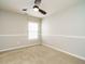 Empty bedroom with carpet, ceiling fan and a large window with natural light at 1833 Creek Oak Circle Cir, Fuquay Varina, NC 27526