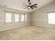 Spacious bedroom with neutral carpet, lots of windows, and ceiling fan at 1833 Creek Oak Circle Cir, Fuquay Varina, NC 27526