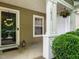 Inviting front porch with decorative wreath, sidelight, hanging plants, and well-maintained landscaping at 1833 Creek Oak Circle Cir, Fuquay Varina, NC 27526