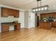 Spacious kitchen offers wood cabinets, a desk area, and a modern light fixture at 1833 Creek Oak Circle Cir, Fuquay Varina, NC 27526