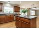 Well-designed kitchen island with stainless steel appliances, countertops, wood cabinets, and a window view at 1833 Creek Oak Circle Cir, Fuquay Varina, NC 27526