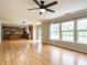 Bright living room features hardwood floors, ceiling fan, and kitchen access at 1833 Creek Oak Circle Cir, Fuquay Varina, NC 27526