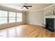 Inviting living room featuring hardwood floors, a fireplace, large windows, and neutral wall color at 1833 Creek Oak Circle Cir, Fuquay Varina, NC 27526