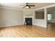 Spacious living room with hardwood floors, a fireplace, and neutral paint colors at 1833 Creek Oak Circle Cir, Fuquay Varina, NC 27526
