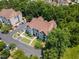 Aerial view of multi-story building complex surrounded by lush greenery and ample parking space at 1912 Parkside Village Dr, Clayton, NC 27520