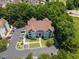 Aerial view of a modern apartment building with a parking lot surrounded by green landscaping and mature trees at 1912 Parkside Village Dr, Clayton, NC 27520