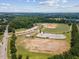 Aerial view of park area with baseball fields, green spaces, and parking lots with trees in the background at 1912 Parkside Village Dr, Clayton, NC 27520