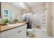 Bathroom featuring a shower-tub combo with a modern vanity and lighting at 1912 Parkside Village Dr, Clayton, NC 27520