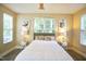 Bright bedroom with plush bed, accent pillows and three windows at 1912 Parkside Village Dr, Clayton, NC 27520