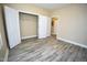 Spacious bedroom with wood-look flooring and closet at 1912 Parkside Village Dr, Clayton, NC 27520