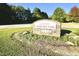 A sign for Clayton Community Park with green lawns and mature trees in the background at 1912 Parkside Village Dr, Clayton, NC 27520